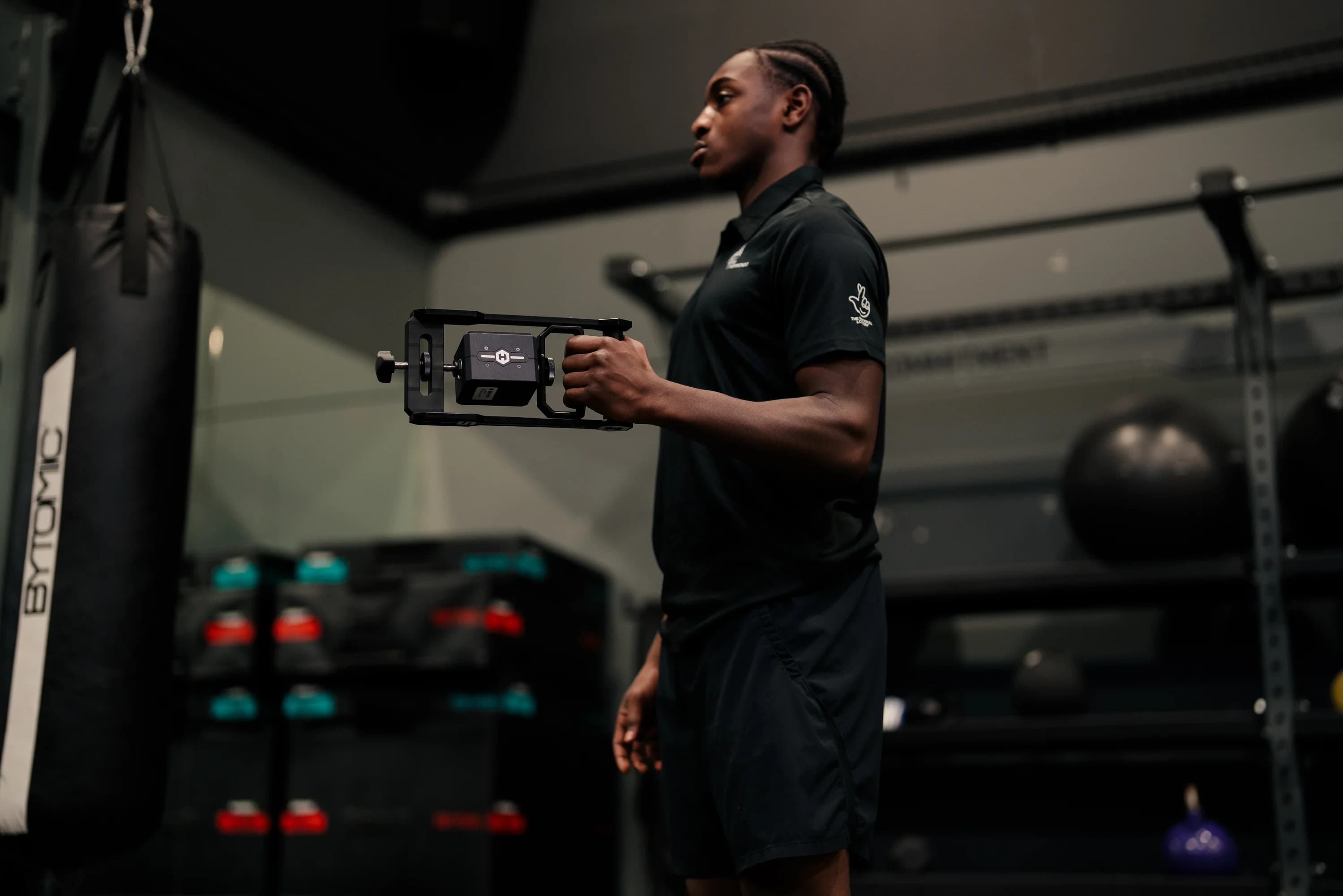 Athlete performing TruStrength muscle test with handheld dynamometer during performance testing in Seattle.